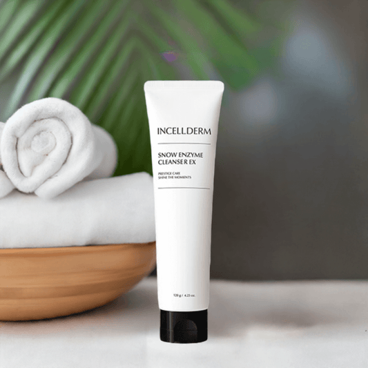 Riman Incellderm Snow Enzyme Cleanser EX on a countertop with towels and greenery, ideal for gentle skin cleansing and hydration.
