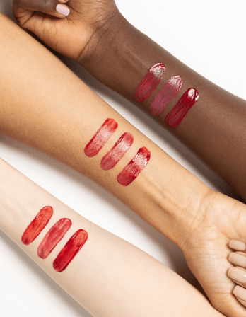 Swatches of ICD Makeup Butter Lip Tint in various shades on diverse skin tones.