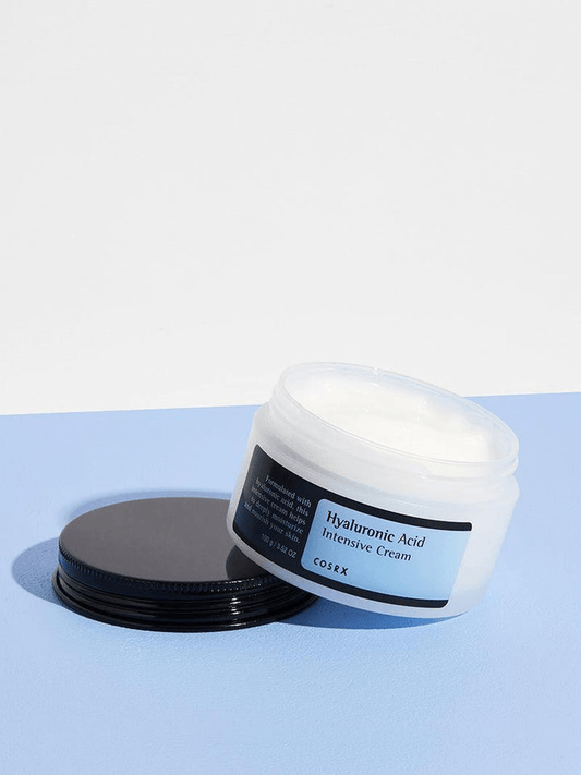 COSRX Hyaluronic Acid Intensive Cream | Korean Moisturizers jar on blue background, showcasing hydrating skincare.