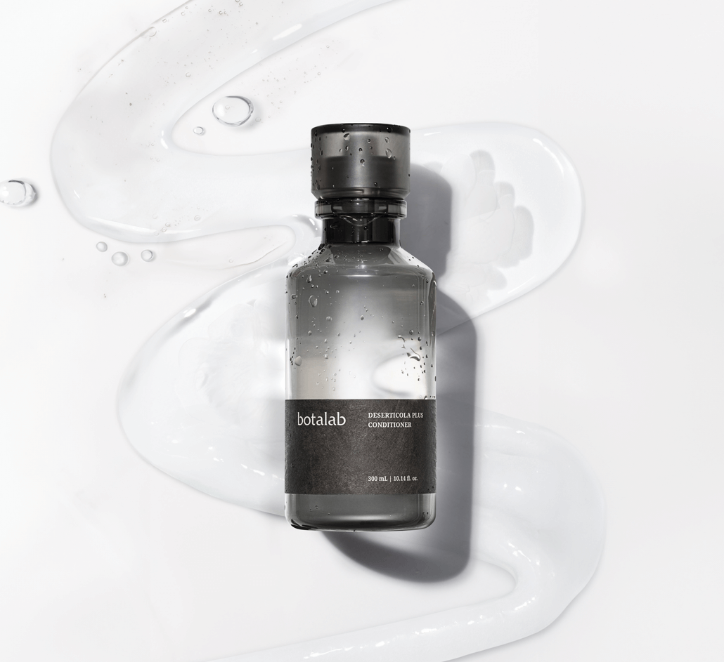 Riman Botalab Deserticola Plus Conditioner bottle on a white background with cleansing gel texture.