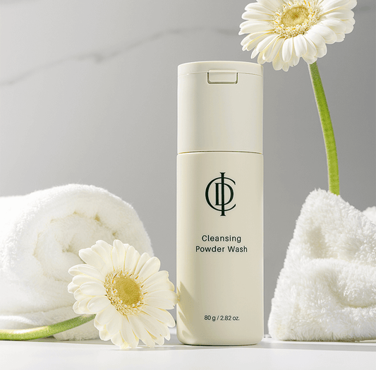 Riman ICD Cleansing Powder Wash with flowers and towels, designed to exfoliate and brighten dull skin for a radiant complexion.