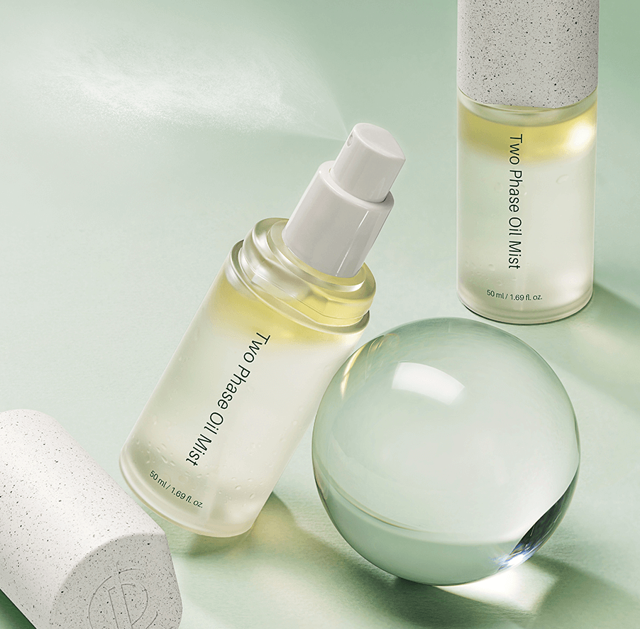 Riman ICD Two Phase Oil Mist bottle with a smooth glass orb, showcasing its hydrating, glowing properties.