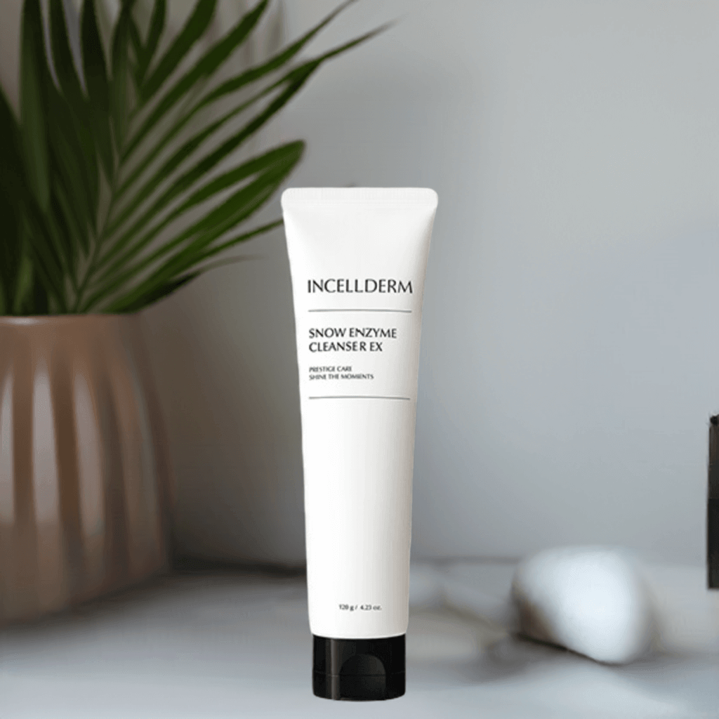 Riman Incellderm Snow Enzyme Cleanser EX in a white tube on a shelf with greenery, effective for gentle cleansing and hydration.