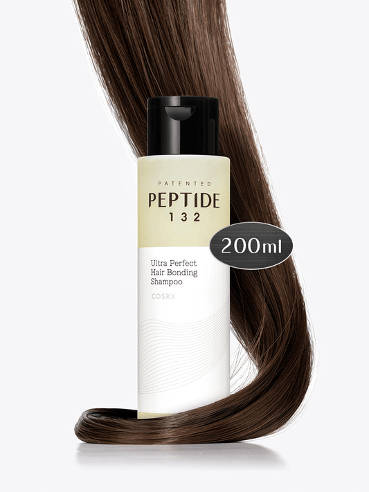 Shampoo bottle labeled 'Peptide 132' with a 200ml capacity, next to a strand of brown hair on a white background.