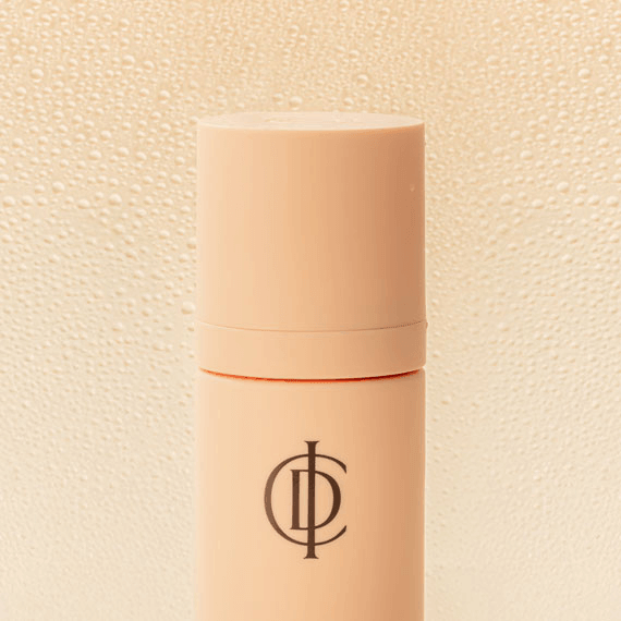 Riman ICD Makeup Set & Stay Makeup Spray in a sleek container with a logo and droplets of water in the background.