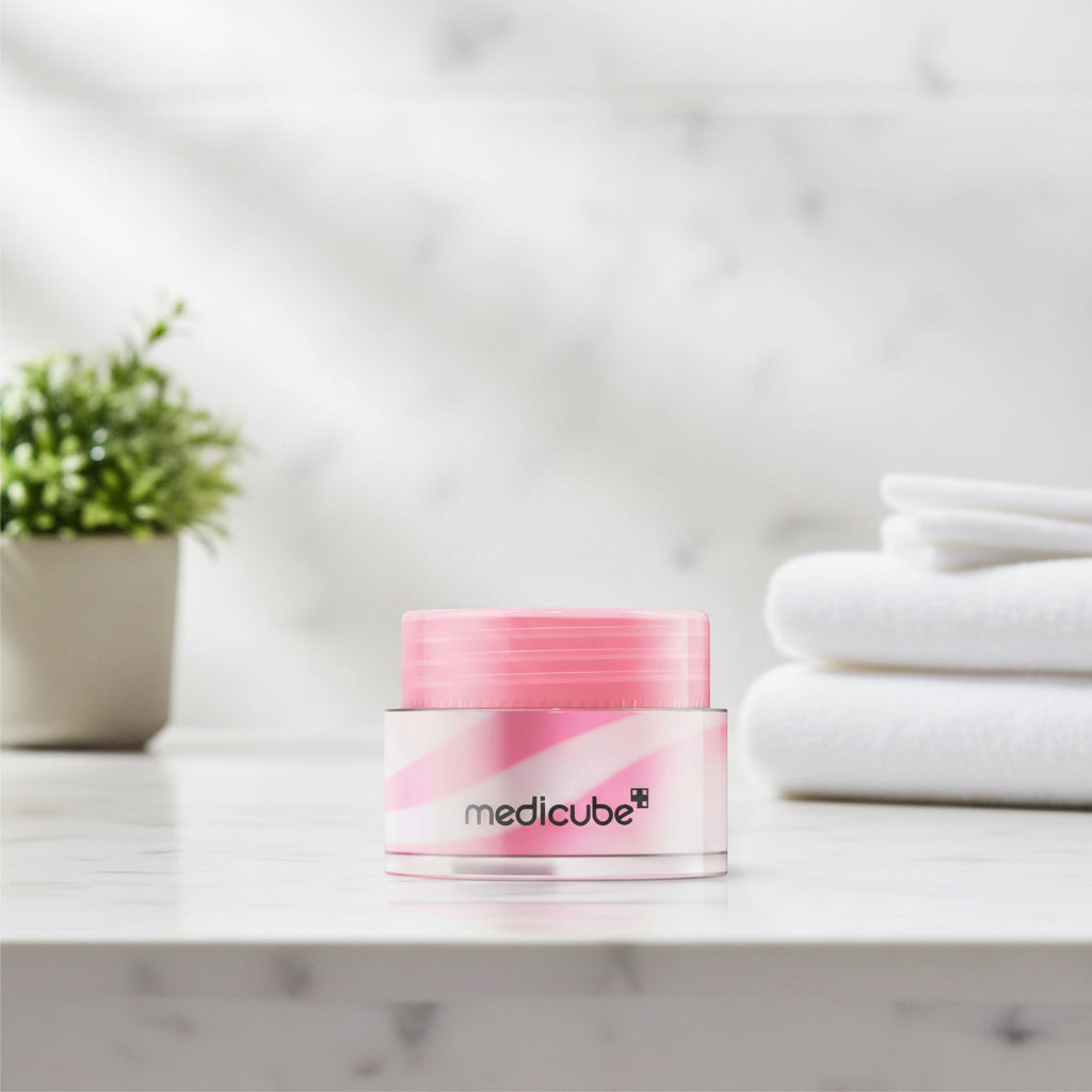 Pink and white cream jar with 'medicube' branding on a white background
