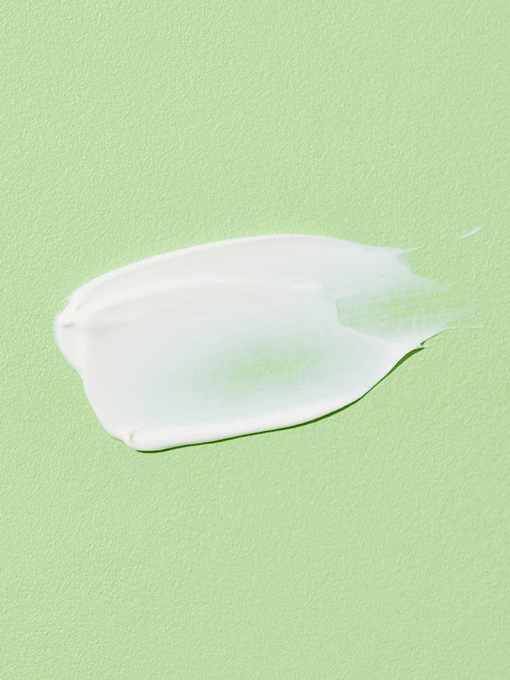 COSRX Aloe Soothing Sun Cream SPF50 | Korean Face Sunscreen spread on green surface