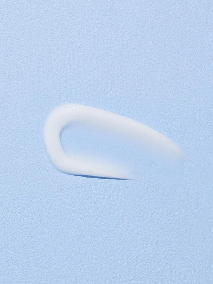 COSRX Hyaluronic Acid Intensive Cream | Korean Moisturizers applied on a blue background, showcasing its smooth texture.