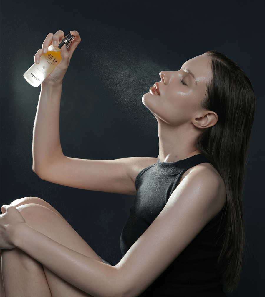 Model using d'Alba White Truffle First Spray Serum, a facial mist for hydration and glow.
