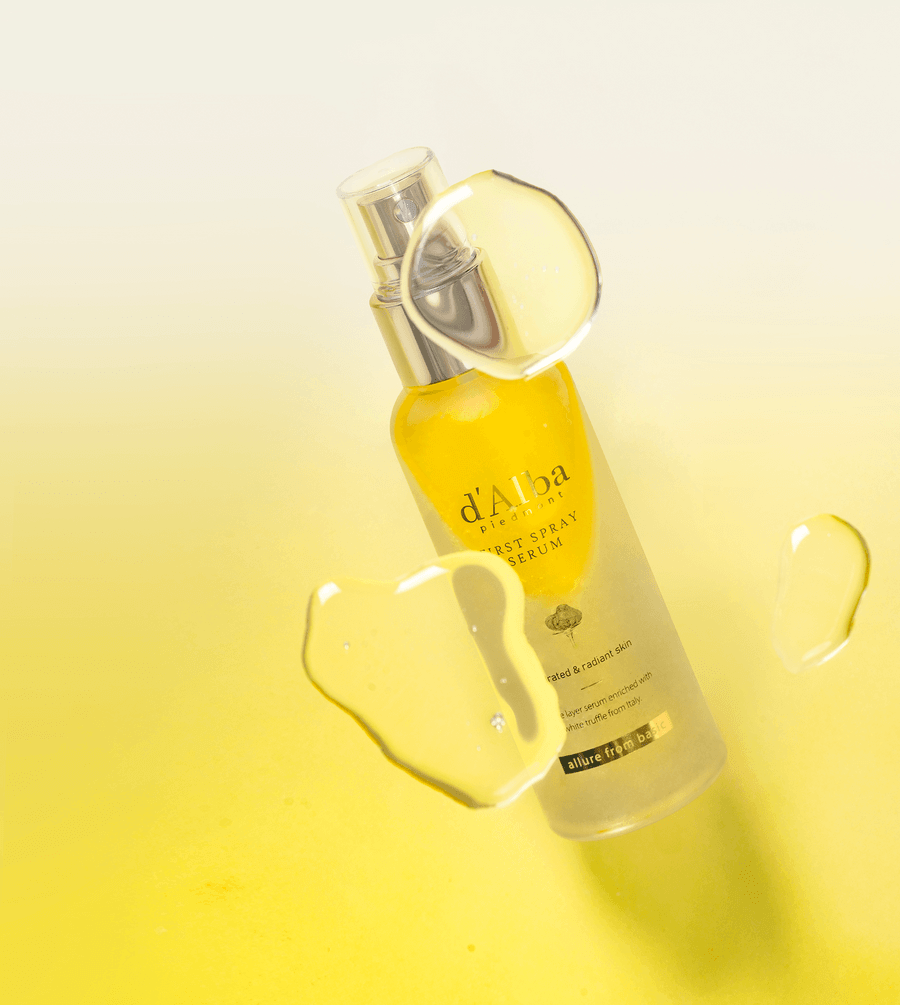 d'Alba White Truffle First Spray Serum in a sleek bottle with yellow accents and moisturizing droplets.