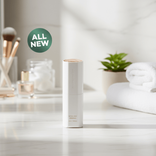 ICD Radiansome 100 Microfluidizer Essence bottle on a marble countertop with spa items and a plant in the background.