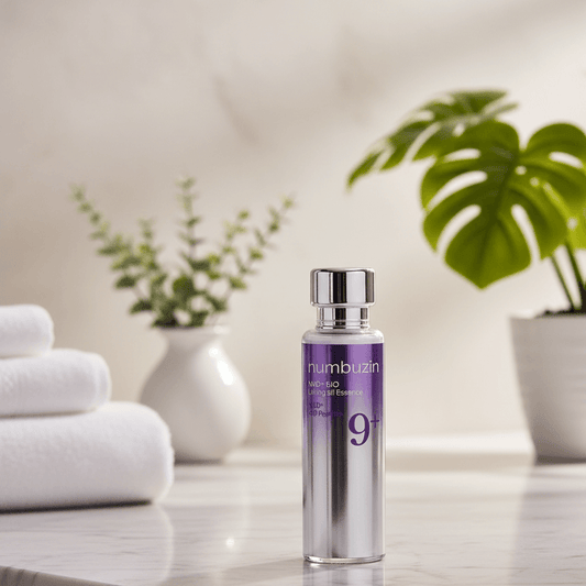 numbuzin No.9 NAD+ BIO Lifting-sil Essence bottle on a marble surface with towels and plants in the background.